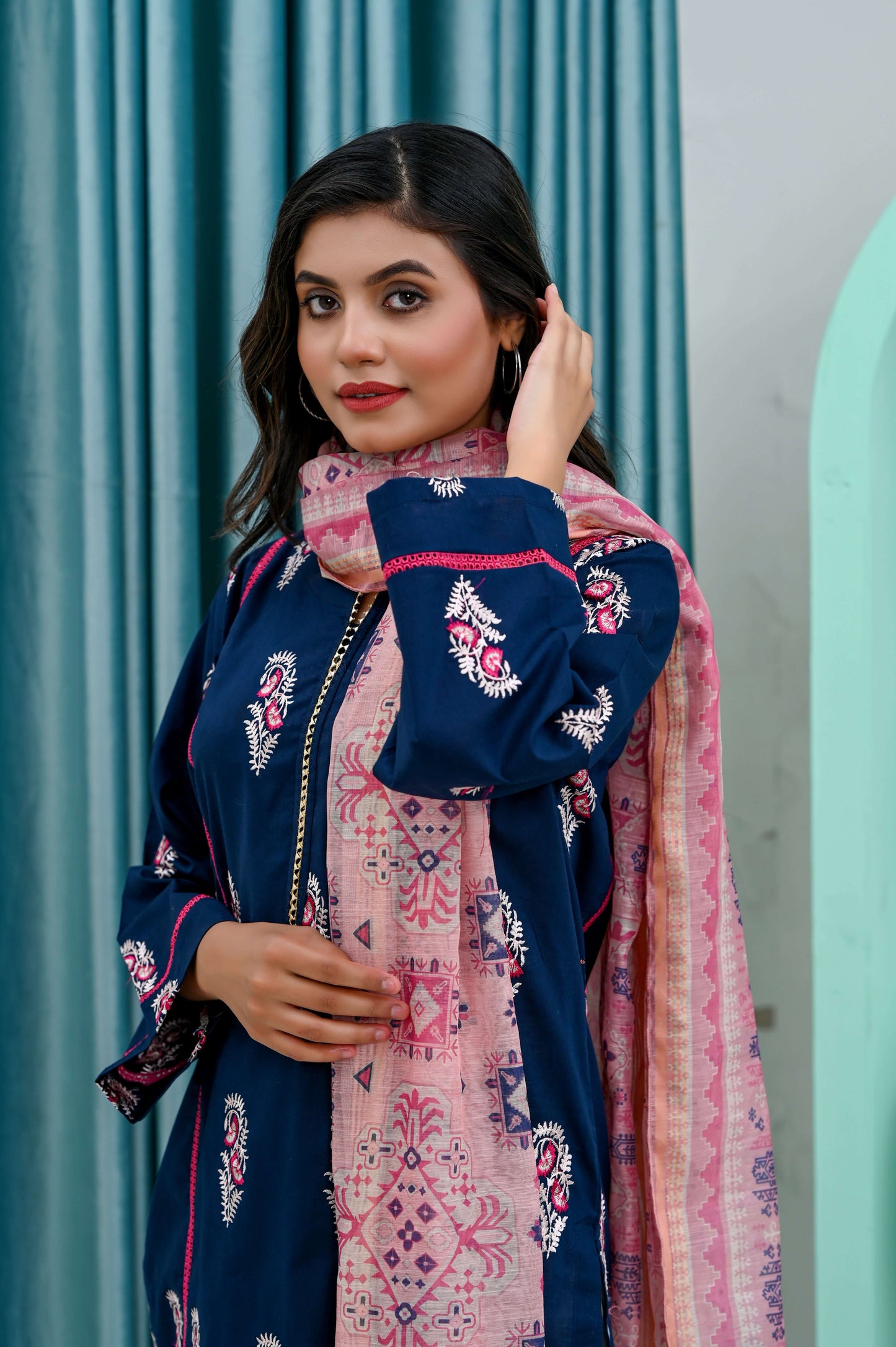 Model showcasing a 2-piece navy blue shirt with a pink dupatta, highlighting refined elegance and stylish detailing.