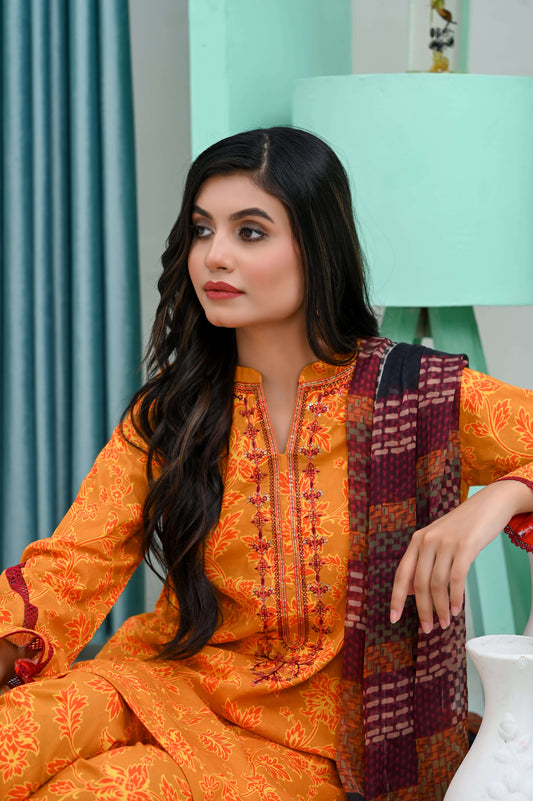 Model wearing a vibrant orange embroidered lawn suit, showcasing intricate details and a stylish dupatta.