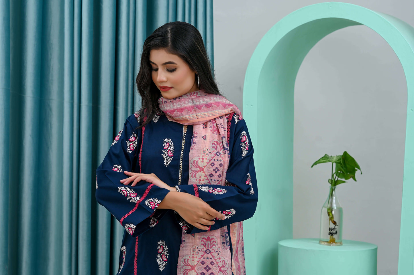 Elegant model in a navy blue shirt with a pink dupatta, showcasing refined style and versatility for semi-formal wear.